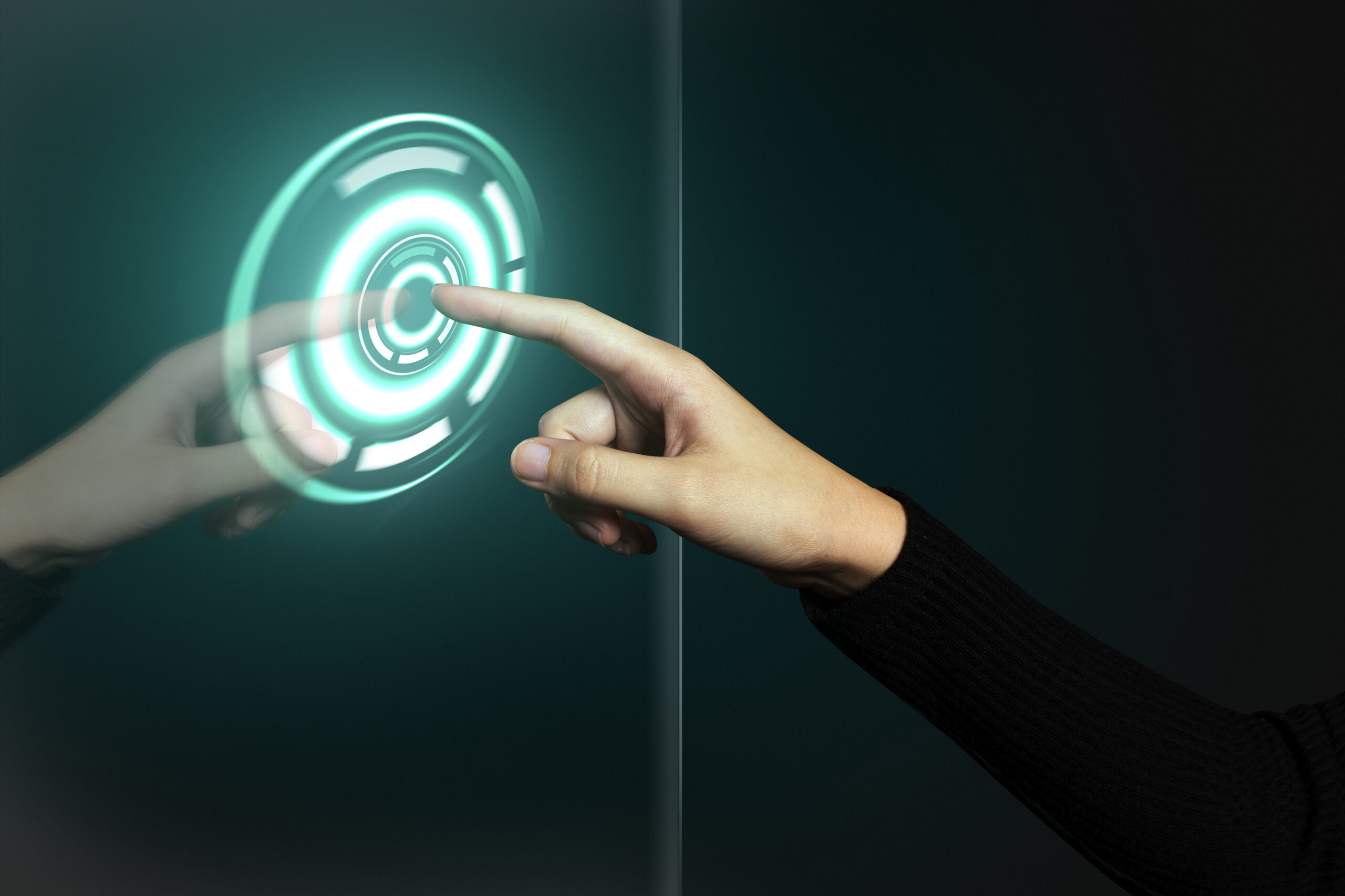 Hand pressing a glowing holographic power button, symbolizing technology upgrades and digital transformation for businesses.