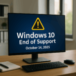 Computer monitor displaying “Windows 10 End of Support October 14, 2025” in a modern office workspace with notepad and keyboard.