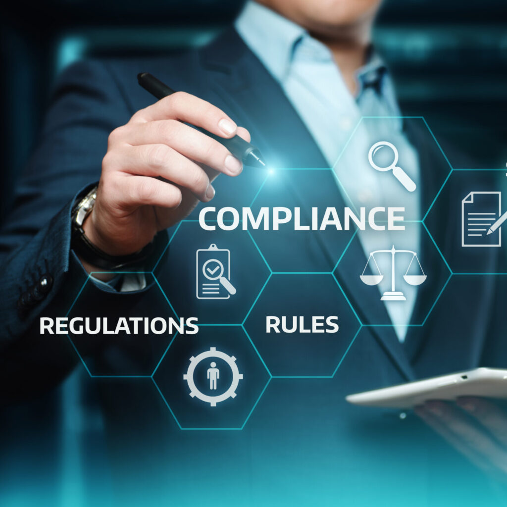 Business professional holding a tablet with digital compliance graphics highlighting regulations, rules, standards, and policies for CMIT Solutions Atlanta