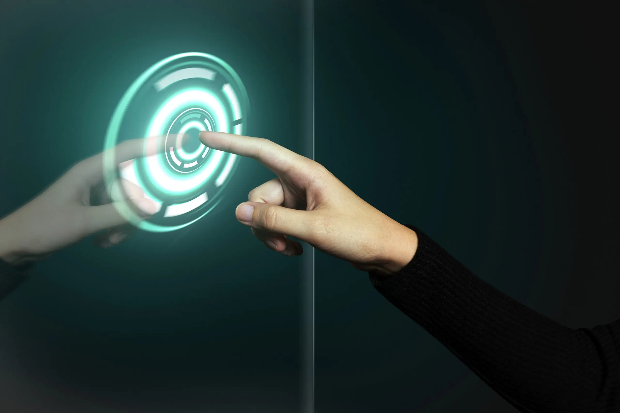 Hand pressing a glowing holographic power button, symbolizing technology upgrades and digital transformation for businesses.