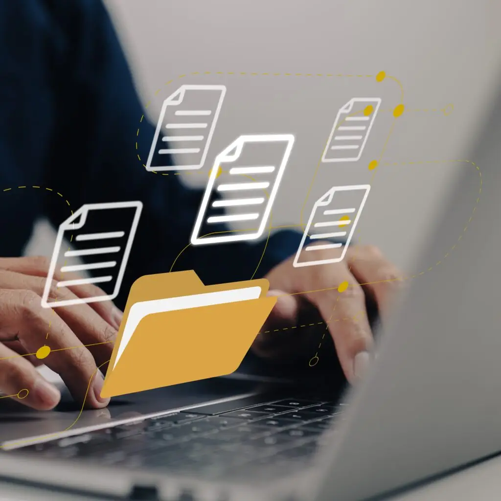 Hands typing on laptop with digital folder and document icons, representing secure file sharing services from CMIT Solutions Atlanta